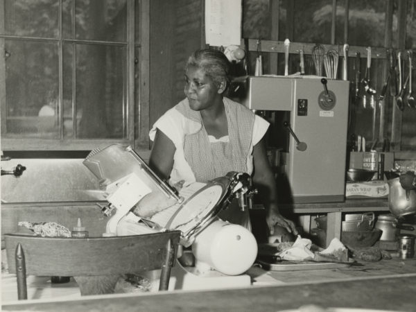 Cook uses meat slicer at the Echo Camp for Girls in Raquette Lake