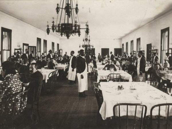 Waiters and guests inside the dining room at Prospect house in Blue Mountain Lake