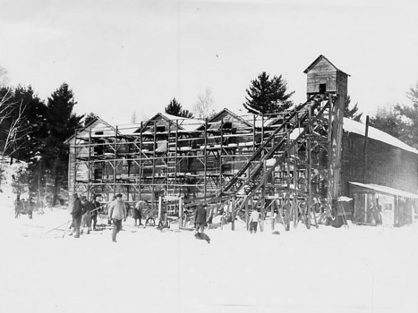 Moving ice blocks into ice house in Saranac Lake