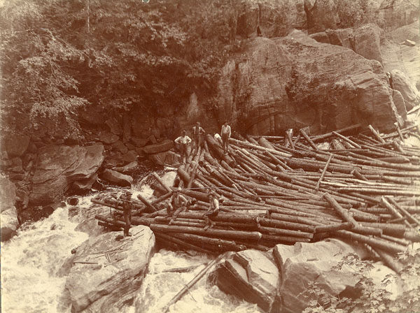 Five loggers on a log jam in the Adirondacks