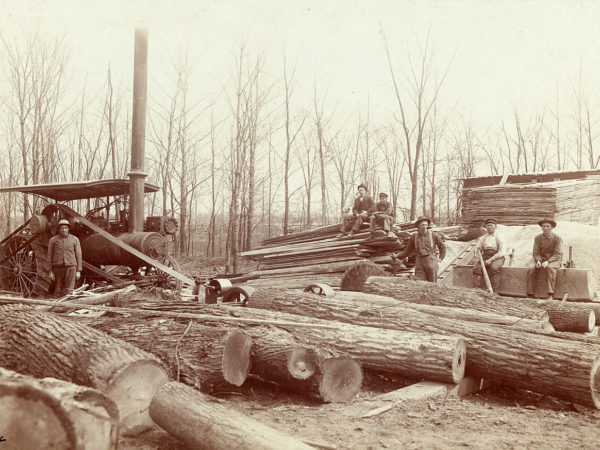 Loggers with steam powered portable sawmill and lumber stacks in the Adirondacks