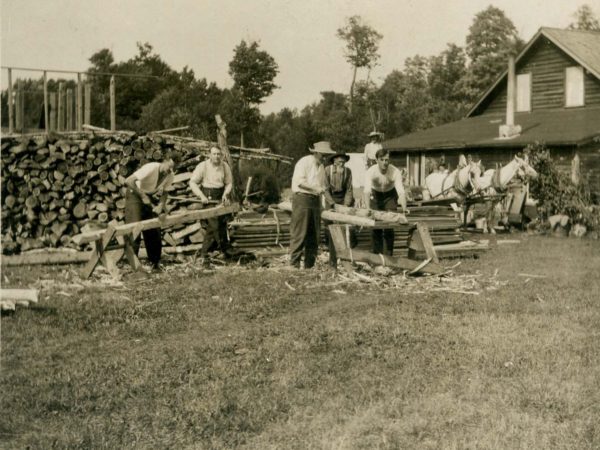 Five men dress logs at Maple Grove Farm near Cranberry Lake
