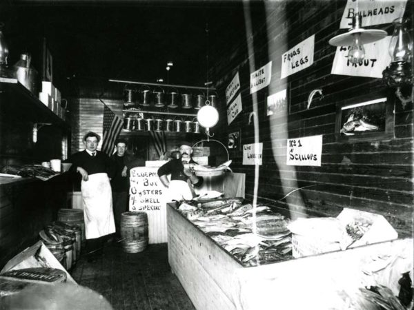 Employees inside fish market in Saranac Lake