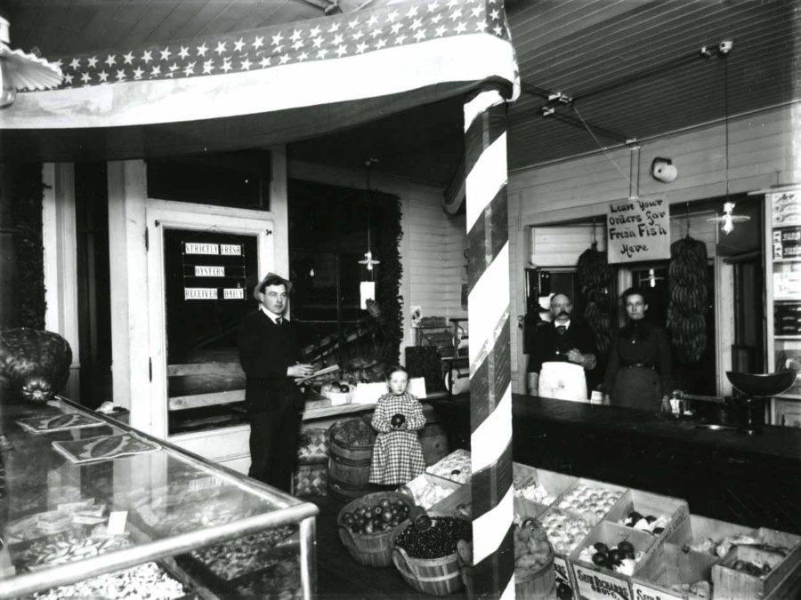 Men behind the counter of the Rogers Company Store in Au Sable Forks