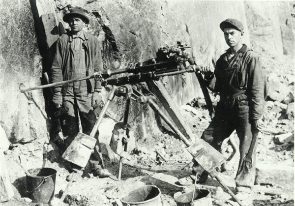 Miners drill into a rock face at the 13th Lake Mine in North