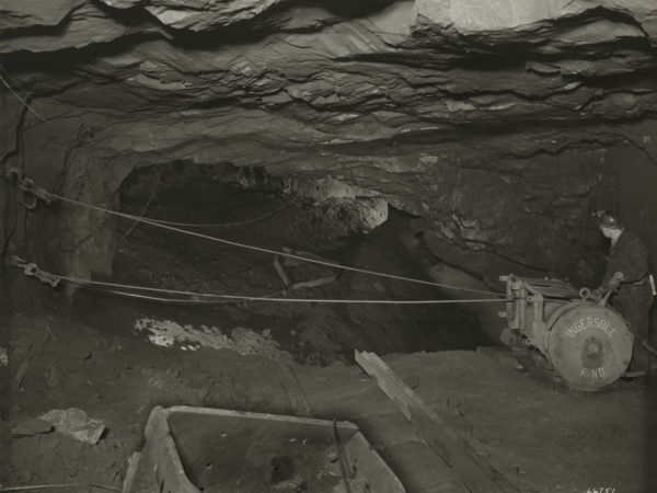 Miner uses a winch system inside a shaft in Essex County