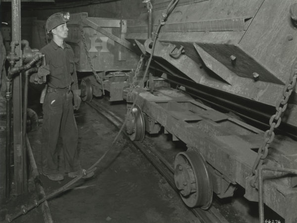 Miner unloads ore car at Republic Steel Company mine in Mineville