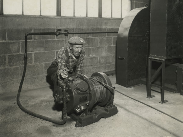 Worker running a winch in Mineville