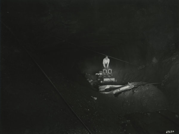 Worker operates a scraper inside a Republic Steel Company mine in Mineville