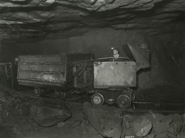 Miner operates an Elmco loader to fill ore car at the Republic Steel Company mine in Mineville