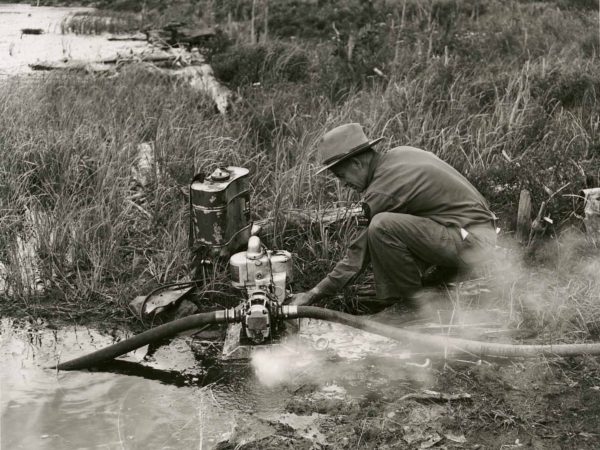 Forest Ranger Franklin Wheeler operates water pump in Warrensburg