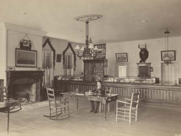 Man at a table in the office of Loon Lake House in Loon Lake