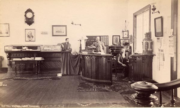 Three men in the office of the Wayside Inn in Luzerne