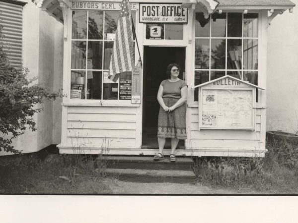 Linda Sturtevant on the front steps of Rubyor’s General Store and Post office in Woodgate