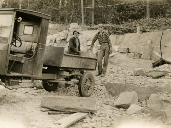 Two men load stone into a truck in the Town of Webb