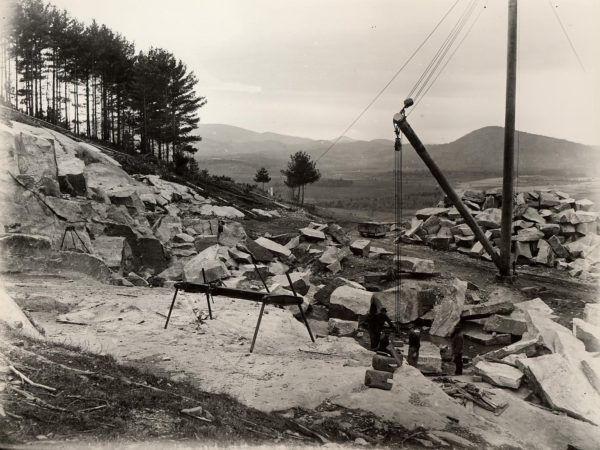 Miners among large blocks of stone at the Ausable Granite Quarry in Keeseville