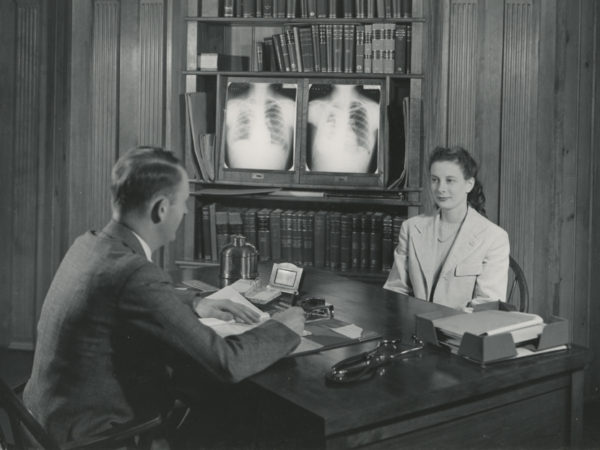 Doctor visits with a patient in the Ray Brook State Tuberculosis