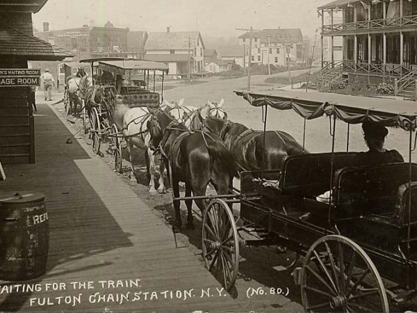 Horse-drawn carriages wait outside the train station in Thendara