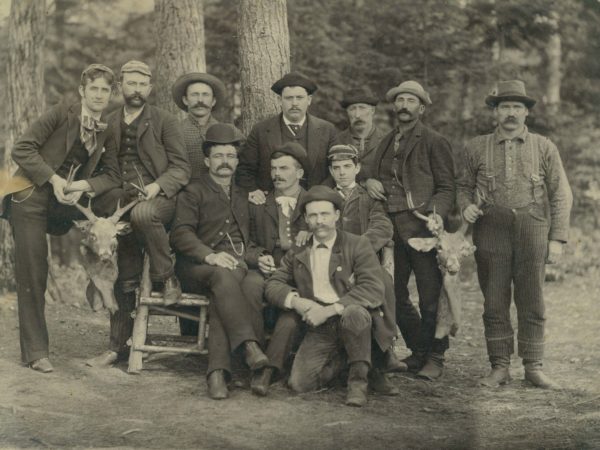 Guides and tourists with deer heads in Paul Smiths