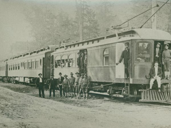 People in and around the cars on Paul Smith's Electric Railroad in Paul Smiths