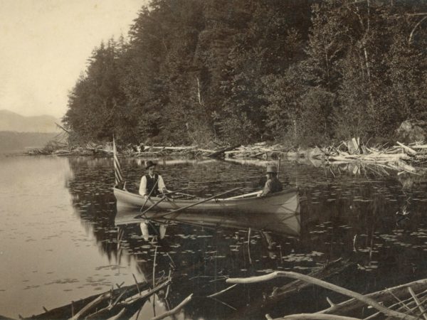 Two men in an Adirondack guideboat in Paul Smiths