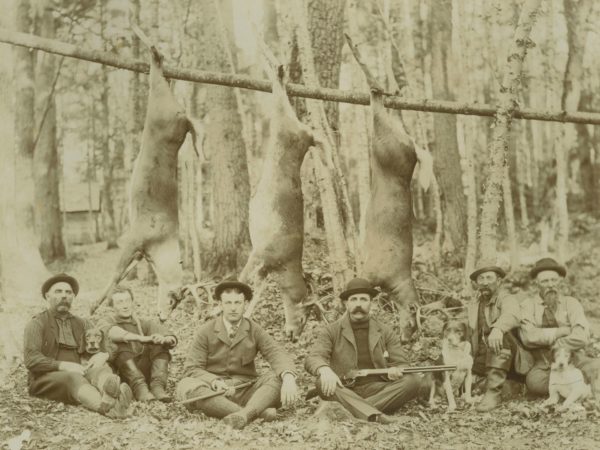 Guides from Paul Smith’s Hotel with trophy deer in Paul Smiths