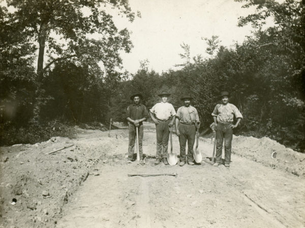 Construction workers pose with shovels and pickaxes in Glens Falls