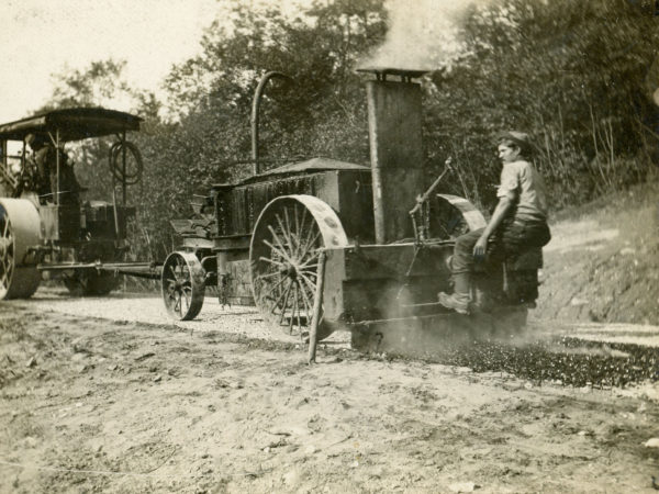 Laying down a tar road with a roller pulling paver in Glens Falls