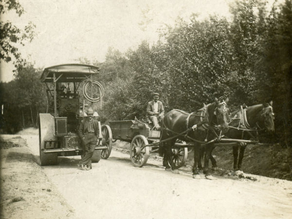 Workers for the D.E. Van Wirt Construction Co. with a horse-drawn dump wagon and steam roller