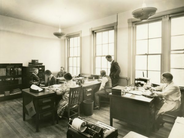 Men and women in an office in the Electric Light Building in Glens Falls