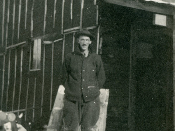 Sam Glover standing outside Lumber Camp III