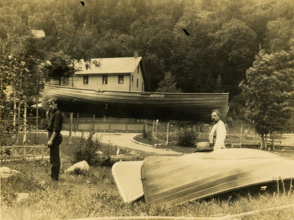 Guideboats and workers outside the Cascade Lakes Hotel in Keene Valley