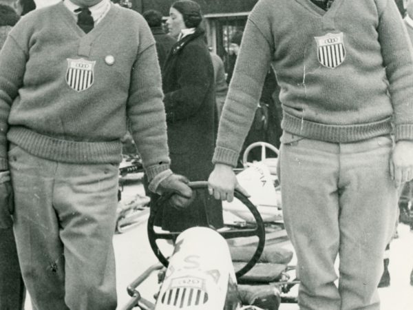 Olympic athletes posing with their bobsled