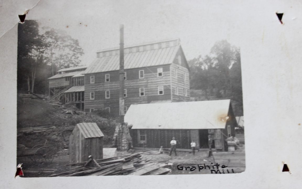Three workers outside of the Johnsburg Graphite Mill