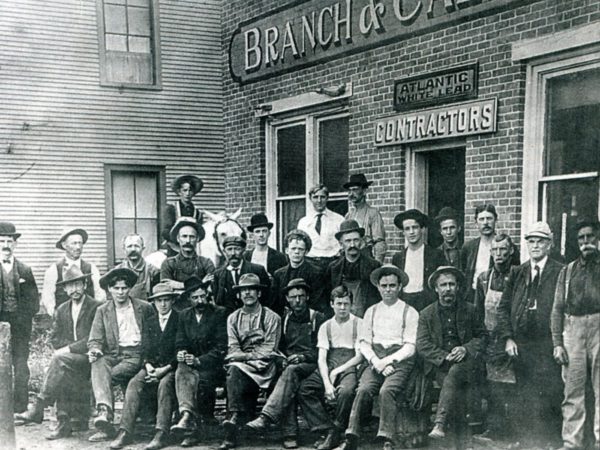 Employees in front of mill and contracting firm Branch and Callanan in Saranac Lake