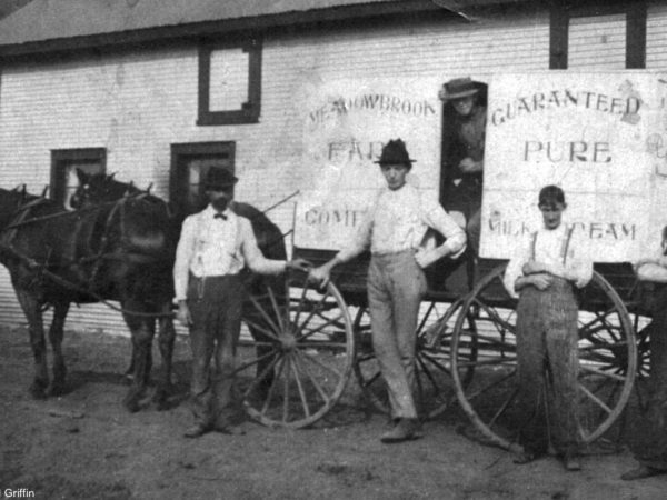 The Meadowbrook Farm crew in front of their delivery wagon in Ray Brook