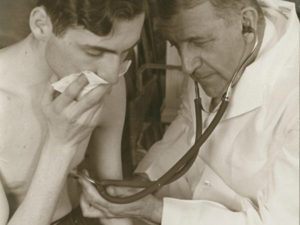 Dr. Trudeau examining a tuberculosis patient in Saranac Lake