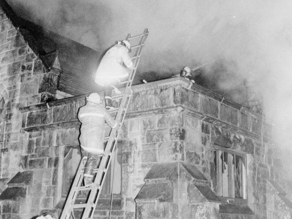 Fighting a fire on top of the All Souls Universalist Church in Watertown