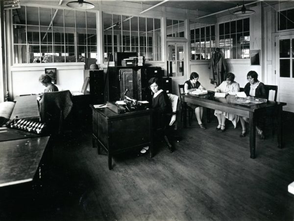 Women doing office work at the Geo Sweetser & Son Shirt Factory in Watertown