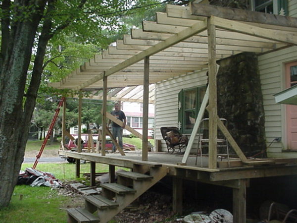 Carrying boards to rebuild a porch in Wanakena