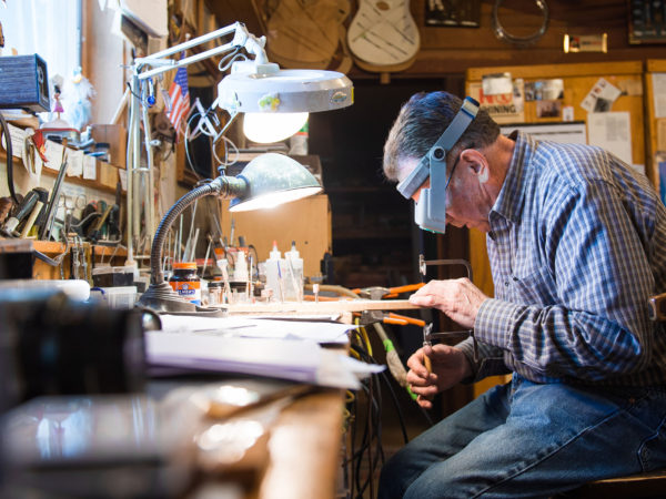 David Nichols crafting a custom guitar in Malone