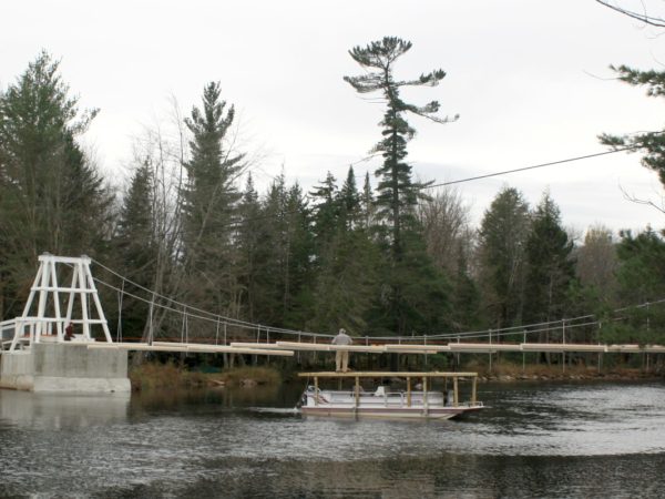 Hauling lumber for the Wanakena footbridge with a pontoon boat