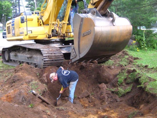 Digging a hole to anchor the cables for the Wanakena footbridge