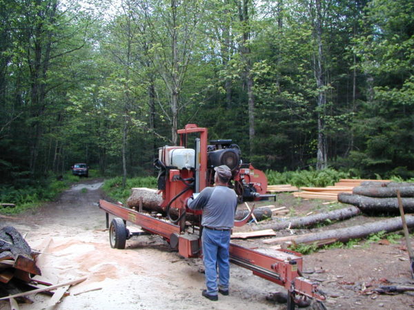 A sawyer using a portable sawmill in Colton