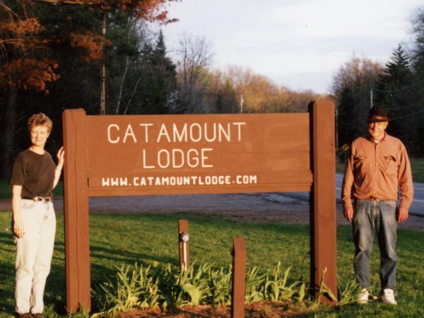 Catamount Lodge owners with the property sign in Colton