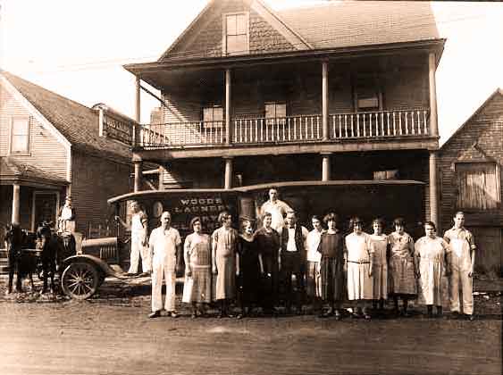 Employees in front of Woods Laundry in Tupper Lake