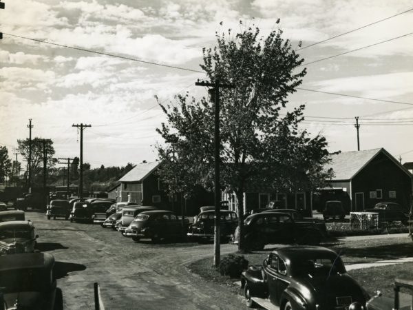 Parked cars in front of the H.L. Neverett & Sons Livestock Commission in Chazy