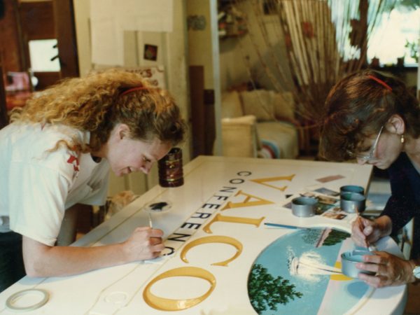 Painting a handmade sign in Plattsburgh