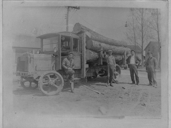 Workers with a Brockway log truck in Tupper Lake