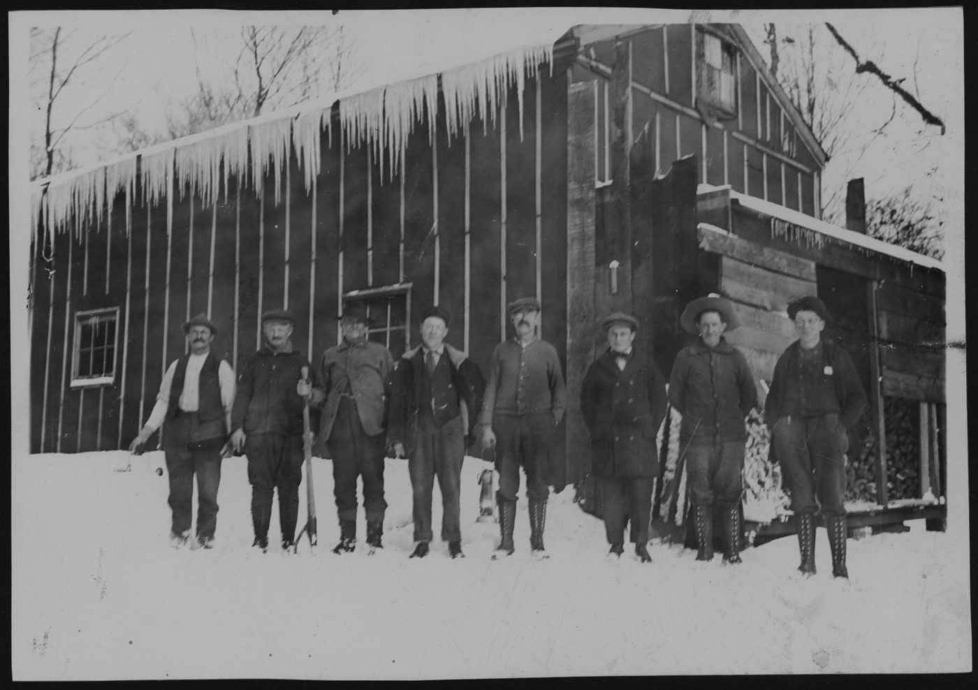 Workers outside a logging camp in Tupper Lake
